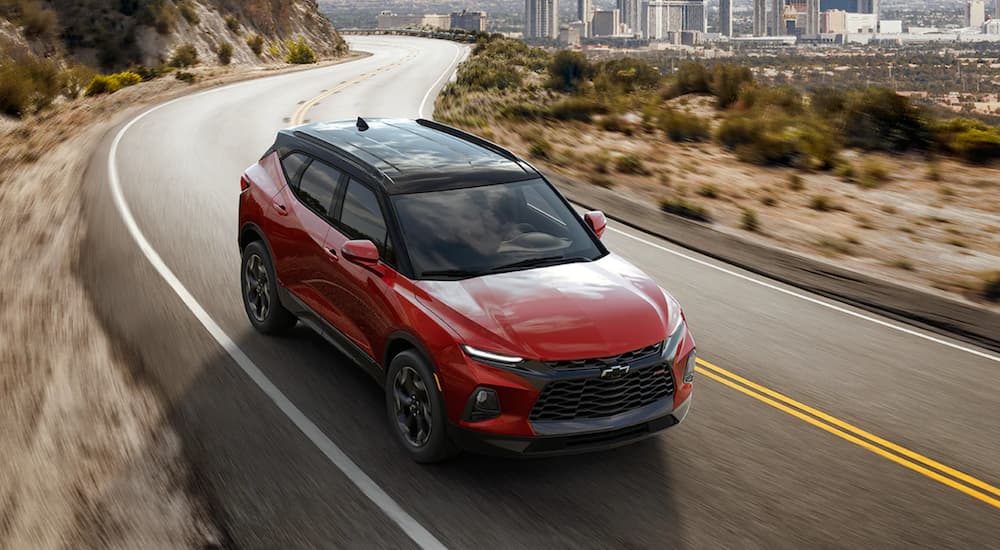 A red 2021 Chevy Blazer RS is shown driving.