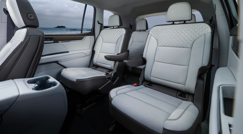 White passenger seats in the interior cabin of a 2024 GMC Acadia for sale.