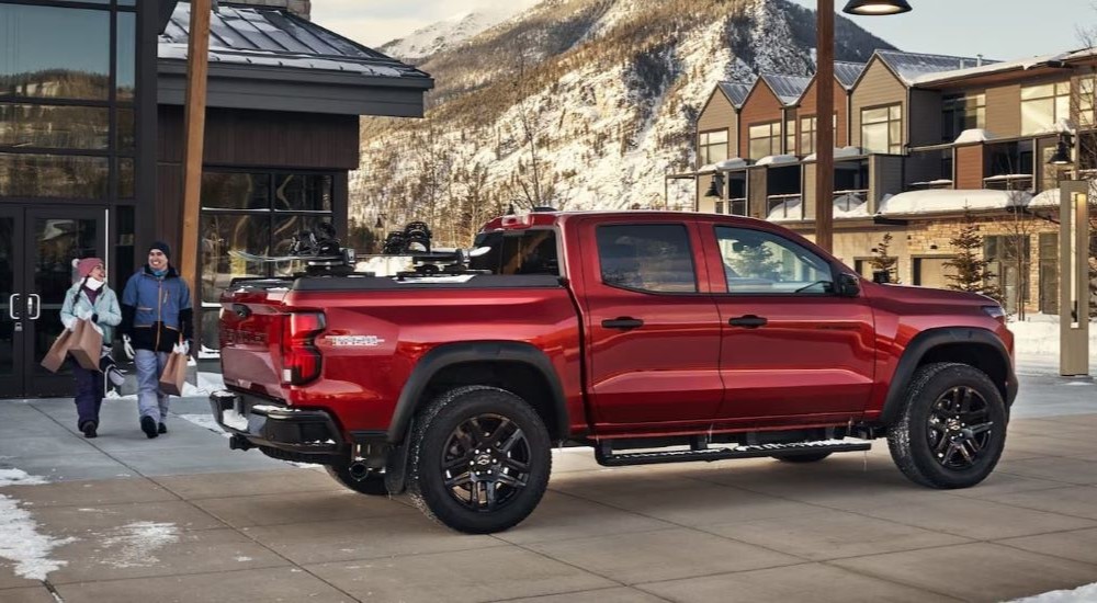 A red 2024 Chevy Colorado Trail Boss parked at a ski resort.