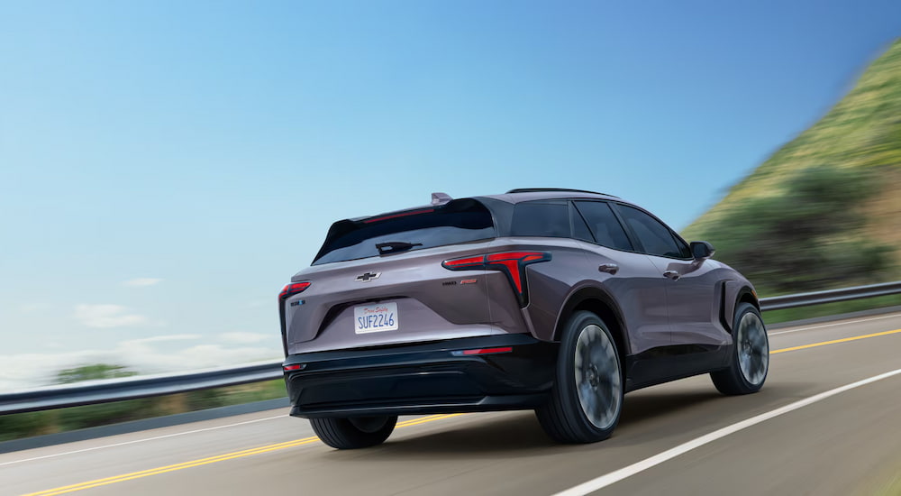 Rear view of a grey 2025 Chevy Blazer EV for sale driving.