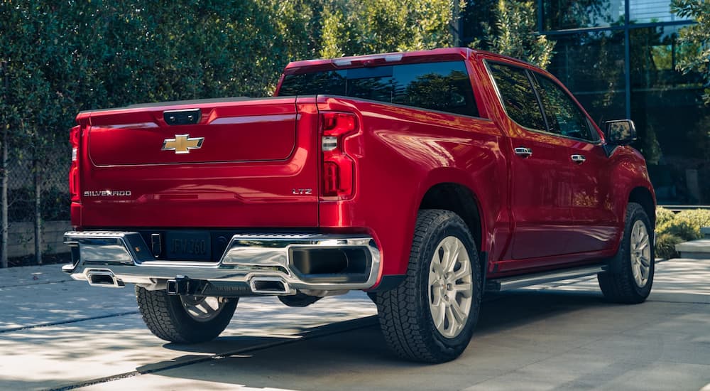 A red 2025 Chevy Silverado 1500 LTZ parked on a driveway.