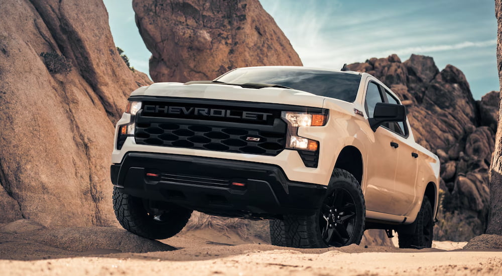 A white 2025 Chevy Silverado 1500 Trail Boss driving off-road.