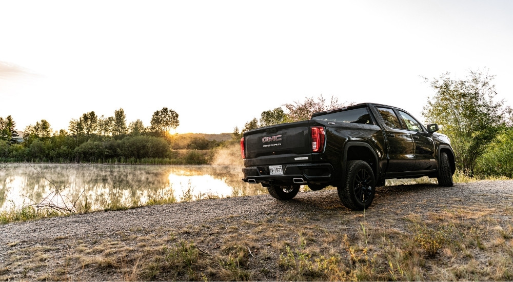 A black 2025 GMC Sierra 1500 Elevation parked off-road.
