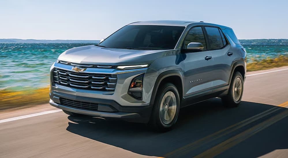 A silver 2026 Chevy Equinox driving to a Chevy dealer near Washington Township.