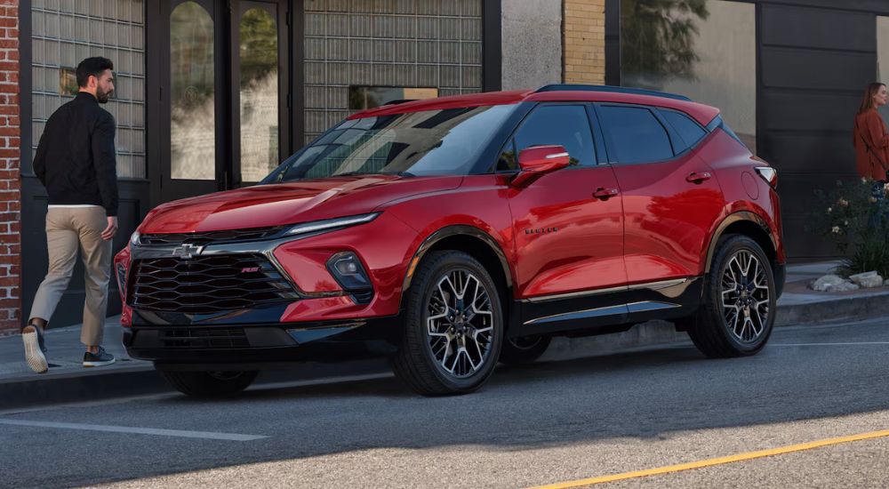 Red 2026 Chevy Blazer parked on a street.