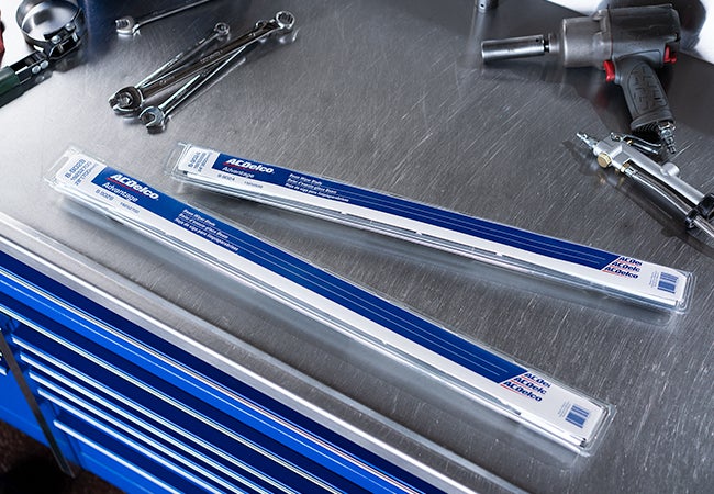 Wiper blades on a blue toolbox.