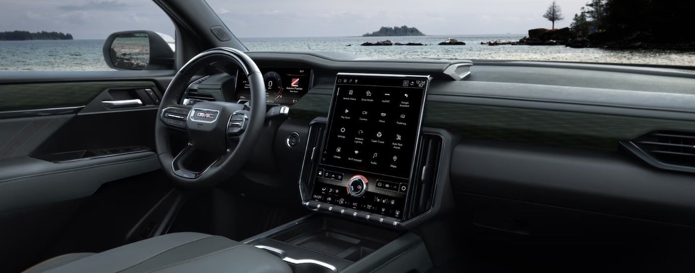 The black interior of a 2024 GMC Acadia for sale.