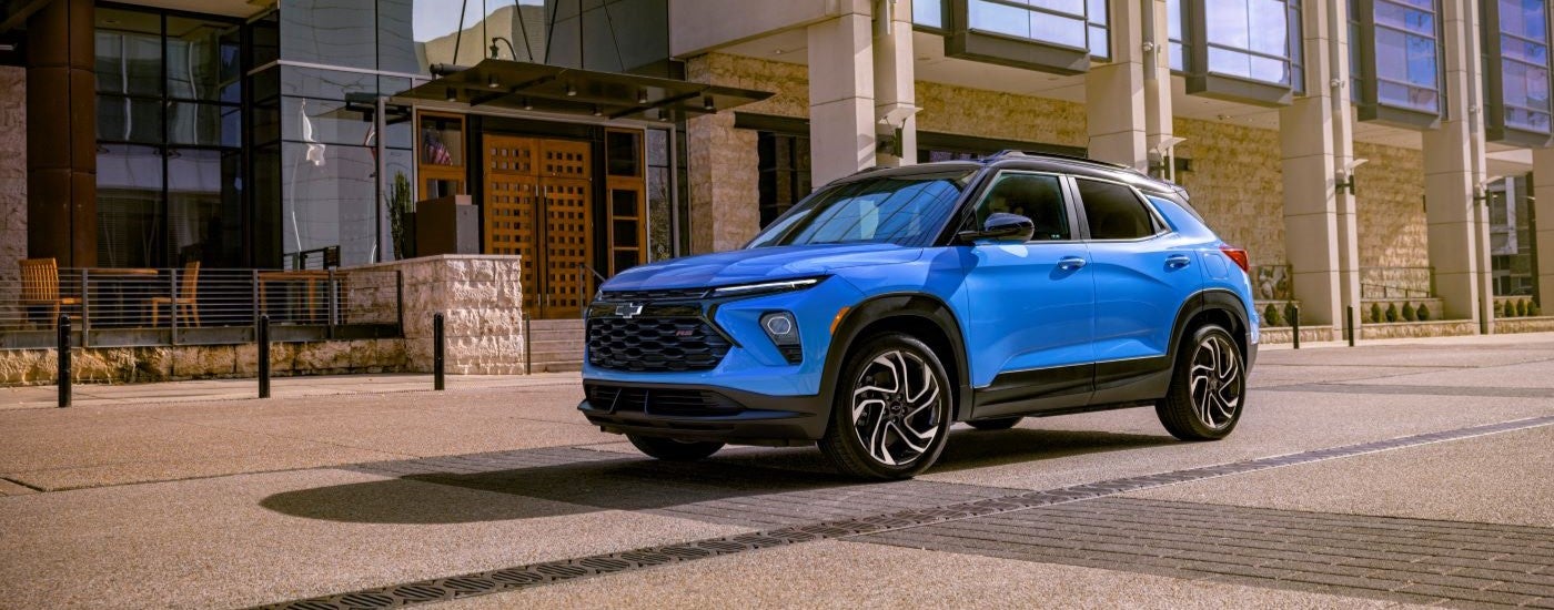 Blue 2026 Chevy Trailblazer RS driving down a street.