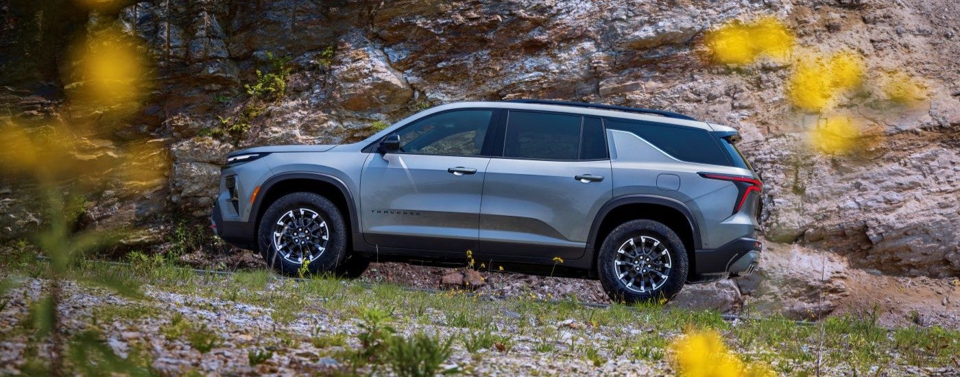 A grey 2024 Chevy Traverse Z71 parked on a field after visiting a Chevy dealer near Clinton Township.