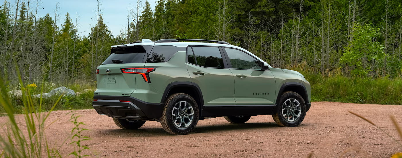 A green 2024 Chevy Equinox ACTIV parked off-road.