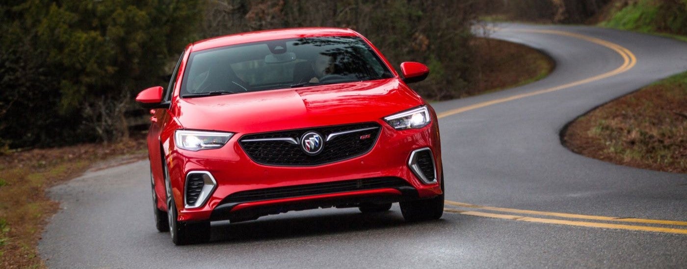 A red 2019 Buick Regal GS driving on a winding road.